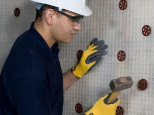 Application of Newton damp proof membrane with plugs