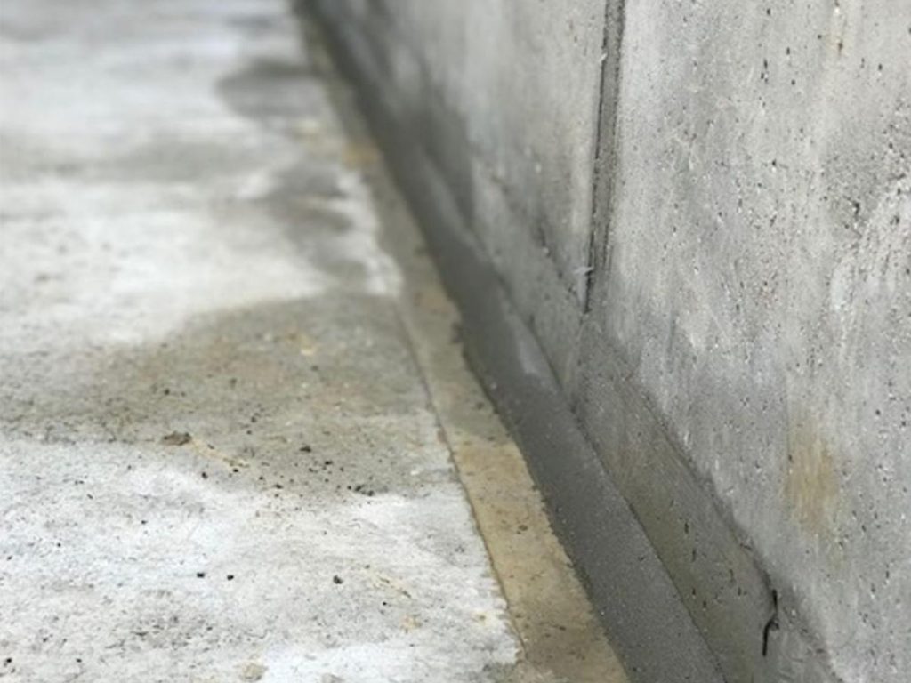 Rapid set repair mortar applied to a wall